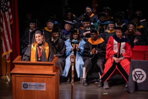 SGA President Ariane Dos Santos speaking at podium during Spring commencement