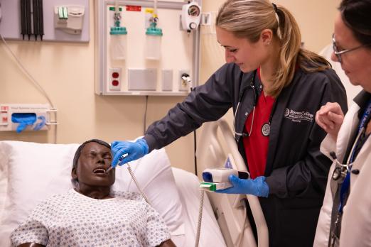 RCBC Nursing student taking a temperature check on a mannequin