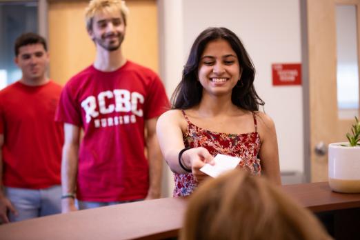 Students line up at the welcome desk of the test center.
