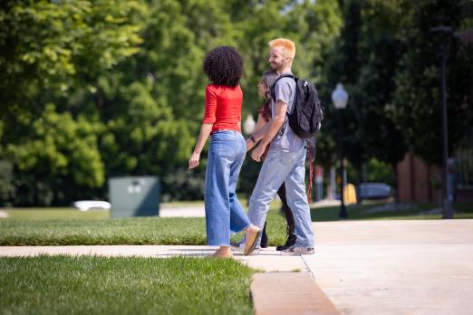 Samarah Schwaeble and Kohen Aselin walk together on campus.