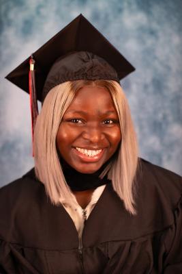 Headshot of Omalayo Akinwole in graduation regalia.