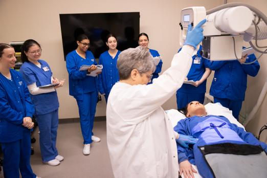 RCBC Radiography students watch a demonstration from a professor.
