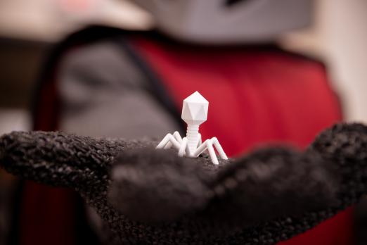 Barry the Baron holding a 3D printed model of a bacteriophage.