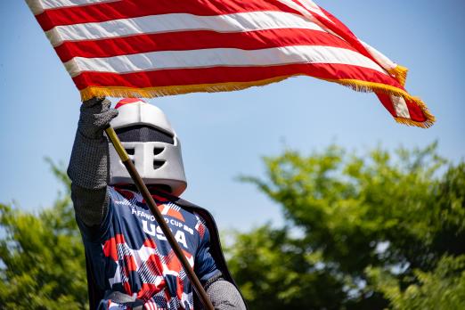 Barry wearing a team USA soccer jersey and holding an American flag