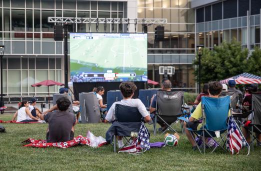 People gather on the SSC quad to watch a FIFA world cup game.