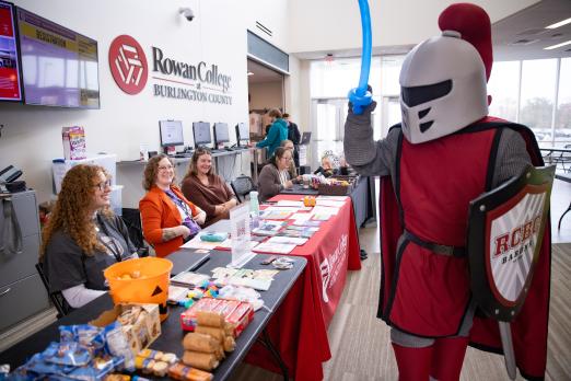 Barry holding a balloon sword while attending Fall into Good Health Fair