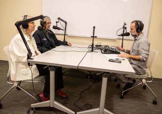 Clockwise from left: Elizabeth Brendle, Faith Zimnes, and Jay Varga chat on the set of the Program Pod.