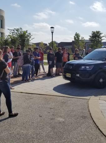 Police officer speaks to students on campus