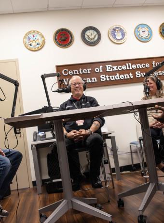 From left to right: Jay Varga, Stephen Hodsdon, Jennifer George, Reginald Taylor chat at microphones.