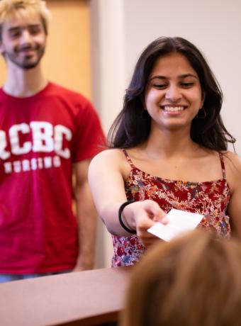 Students line up at the welcome desk of the test center.