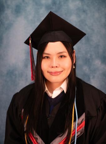 Headshot of Yvonne Tai in graduation regalia.