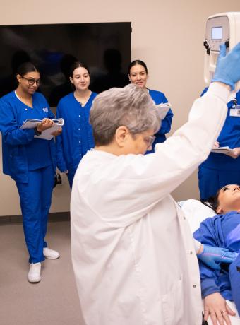 RCBC Radiography students watch a demonstration from a professor.