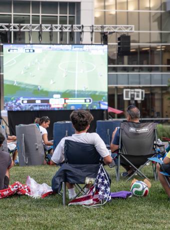 People gather on the SSC quad to watch a FIFA world cup game.
