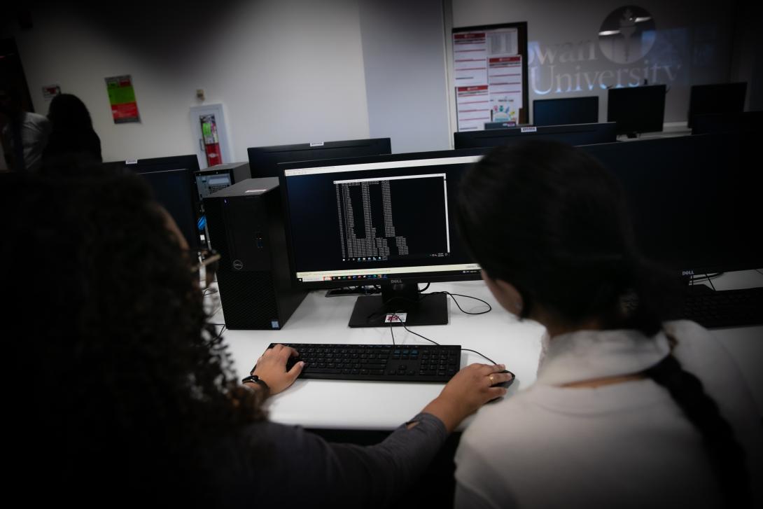 Cybersecurity students work on a computer in the RCBC computer labs.