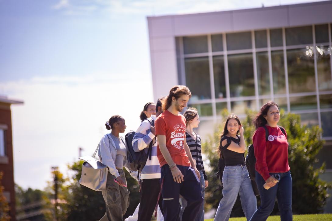 A group of RCBC students walk happily on the RCBC quad.